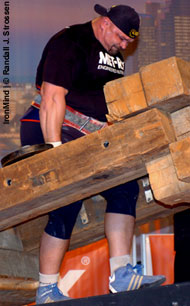 Vasyl Virastyuk (Ukraine) fighting his way up the ramp on the MET-Rx Timber Carry at the 2006 Arnold Strongman contest. IronMind® | Randall J. Strossen, Ph.D. photo.