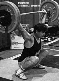 Here is Yoto Yotov as a young lifter, shown in the training hall at the 1990 Goodwill Games. Lifting for the powerhouse Bulgarian weightlifting team, Yotov was a silver medalist at the 1992 and the 1996 Olympics, and he collected piles of medals in European and World Weightlifting Championships. Yotov won the 76-kg class at the 1997 Worlds, where he snatched 165 kg and cleaned and jerked 202.5 kg. IronMind® | Randall J. Strossen, Ph.D. photo.