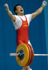 "Yes!" On his way to Olympic gold in Athens, 69-kg weightlifter Zhang Guozheng (China) celebrates his successful 157.5-kg snatch at the 2004 Olympics. Zhang Guozheng and his teammate Shi Zhiyong will be lifting on the main Expo stage at the Arnold this Saturday at approximately 2:00 p.m. IronMind® | Randall J. Strossen, Ph.D. photo.