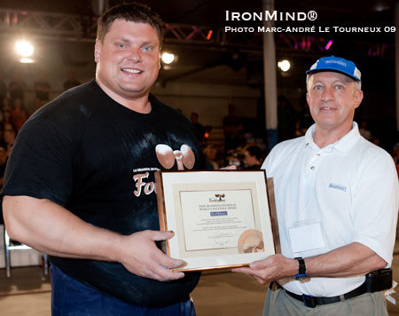 Along with the overall title, Zydrunas Savickas (left) won the IronMind® Overhead World Challenge at Fortissimus and received the award from IronMind®’s Randall Strossen.  IronMind® | Photo by Marc-André Le Tourneux 09, courtesy of Canada World Strength.