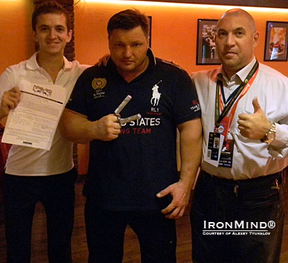 Alexey Tyukalov (center), just certified on the Captains of Crush (CoC) No. 3 gripper, is flanked by his referee, Oleg Chernov of AerRus (left), and by the president of the Armlifting Association of Russia, Nikolai Vitkevich (right).  IronMind® | Courtesy of Alexey Tyukalov. 