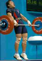 Udomporn Polsak finishes the pull on her world record clean and jerk. IronMind® | Randall J. Strossen, Ph.D. photo. Udomporn Polsak finishes the pull on her world record clean and jerk. IronMind® | Randall J. Strossen, Ph.D. photo.