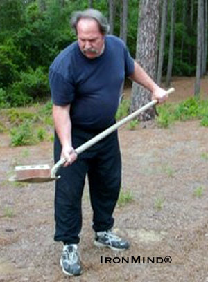 The starting position for the sudden impact exercise—John Brookfield uses a brick to demonstrate this month's Grip Tip.  IronMind® | Photo courtesy of John Brookfield.